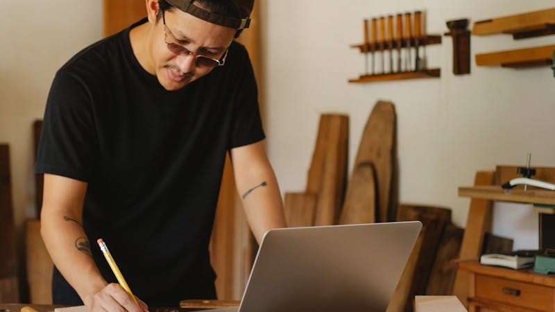 An entrepreneur managing their business tools and workspace on a laptop