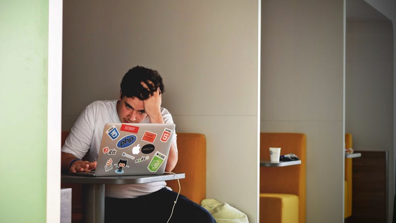 Developer working through a frustrating debugging session at their desk