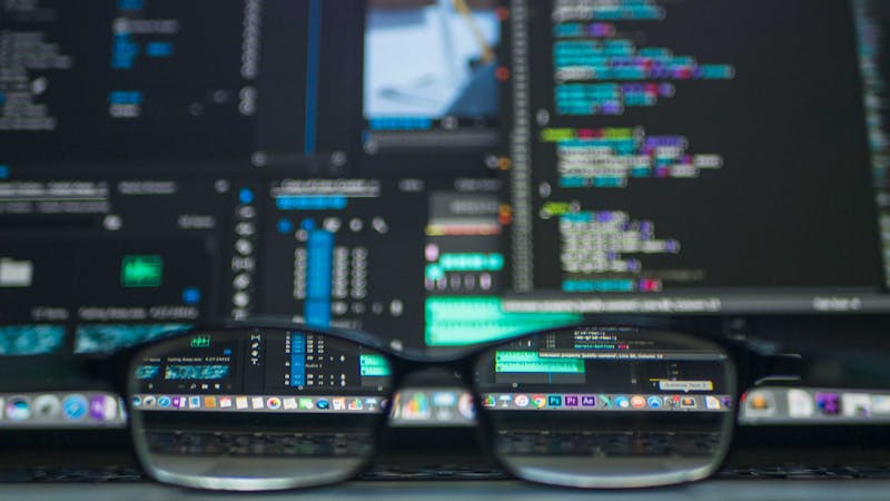 Developer working with database toolkit and code editor on a laptop