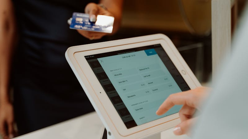 Customer completing a checkout form with payment details on screen