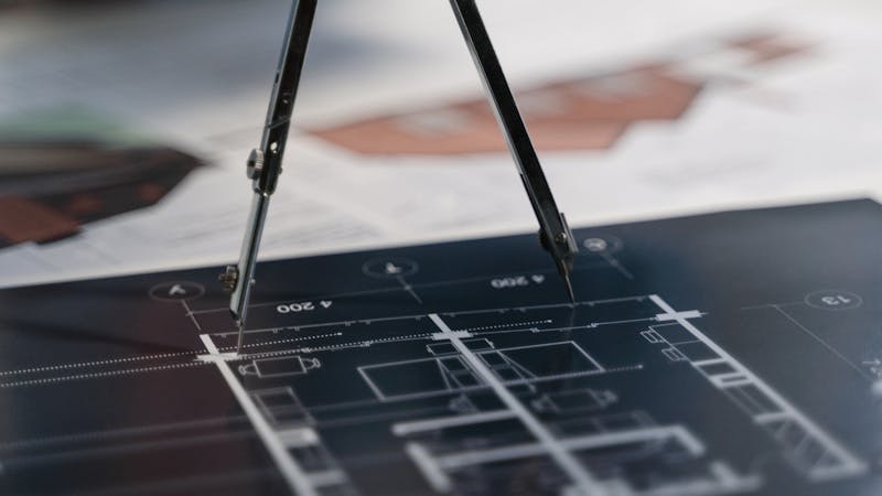 Blueprint and planning documents spread across a workspace