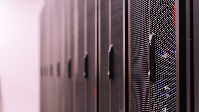 Server room with rows of technology infrastructure and blinking lights