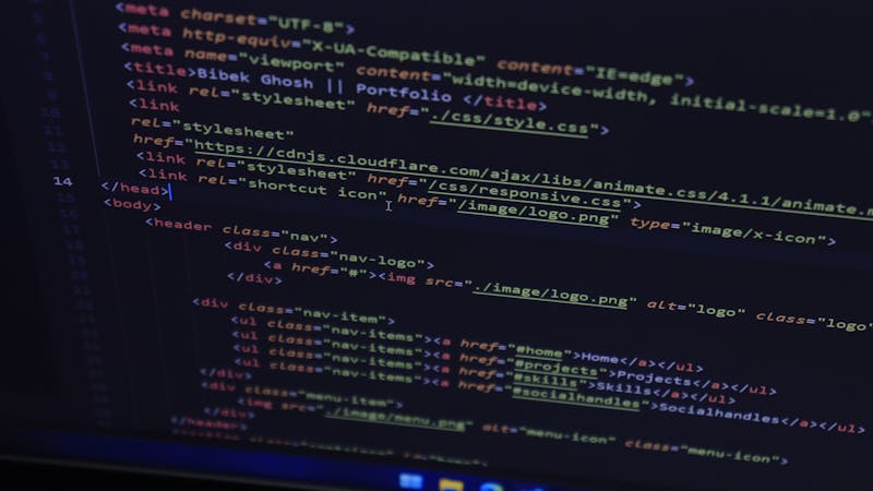 Frontend development code displayed on a monitor showing modern JavaScript syntax