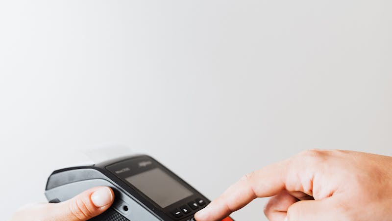 Person completing an online credit card payment on a laptop