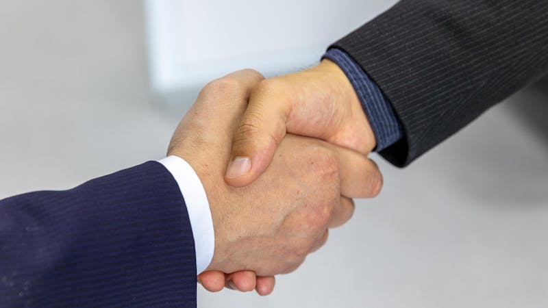 Business partners shaking hands after reaching an agreement