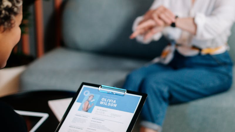Researcher conducting a user interview and taking notes