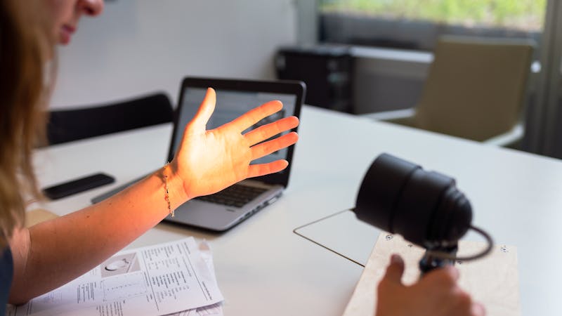 User testing a prototype application on a laptop screen