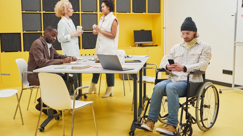People using inclusive technology together in a collaborative setting