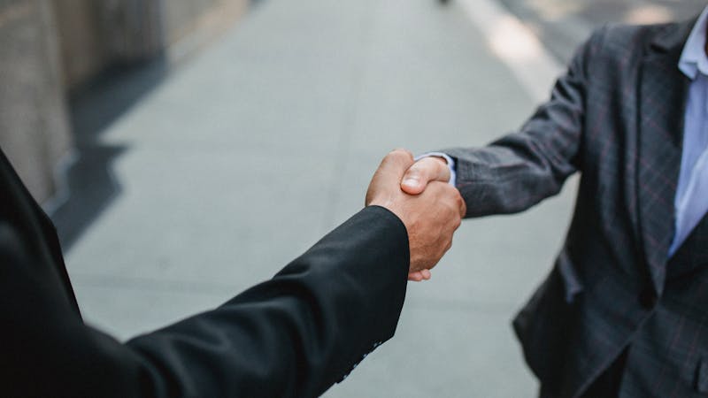 Business partners shaking hands in a professional meeting